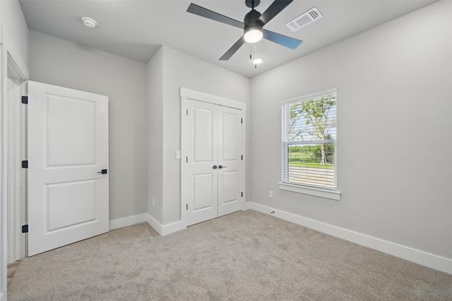 Unfurnished bedroom featuring a closet, carpet flooring, a ceiling fan, baseboards, and visible vents | Image 14