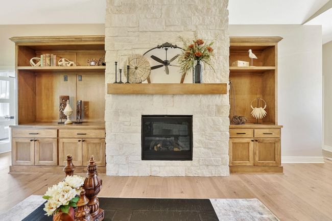 Living room with a fireplace and light hardwood / wood-style flooring | Image 13