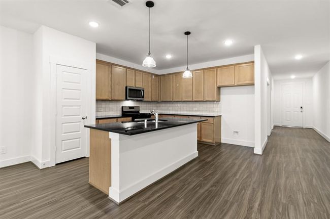 The high ceilings soar above, drawing your gaze to the elegant light fixtures that dance with soft illumination, casting a gentle glow across the space. | Image 5