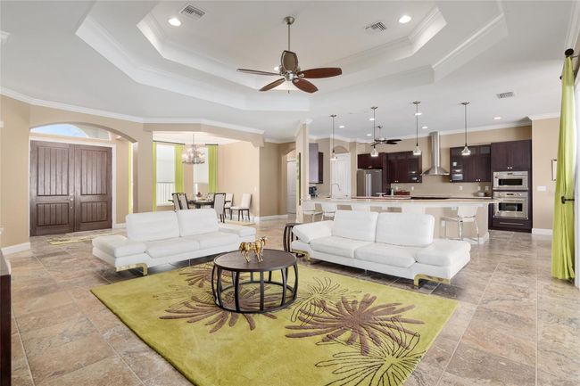 View from triple sliders encompassing dining room, living room, and kitchen | Image 34