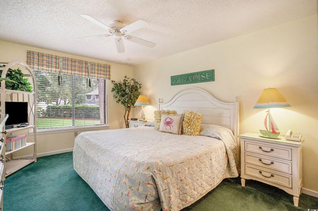Primary king bedroom with sweeping grounds view and an en-suite bathroom and dressing area. | Image 11