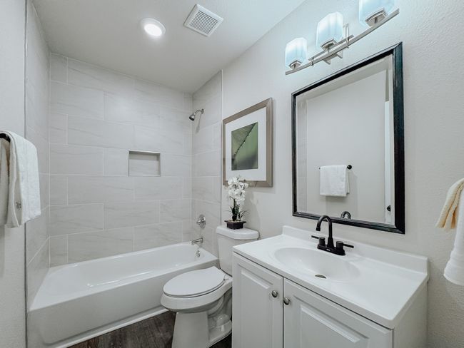 Full bathroom with vanity, wood finished floors, and shower combination | Image 26