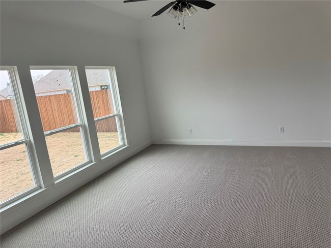 Carpeted empty room with ceiling fan | Image 7