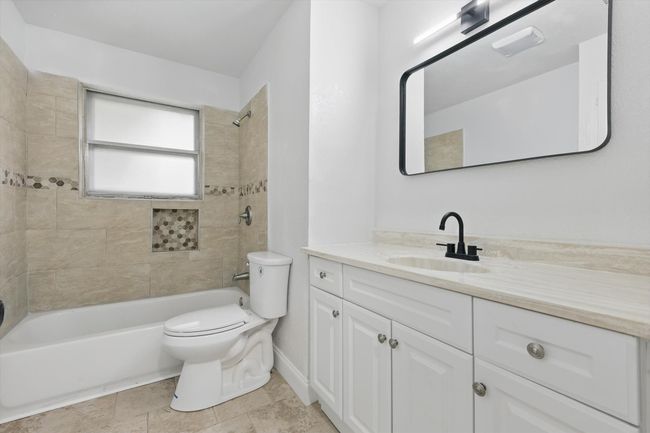 Full bath featuring vanity, toilet, and shower / tub combination | Image 16