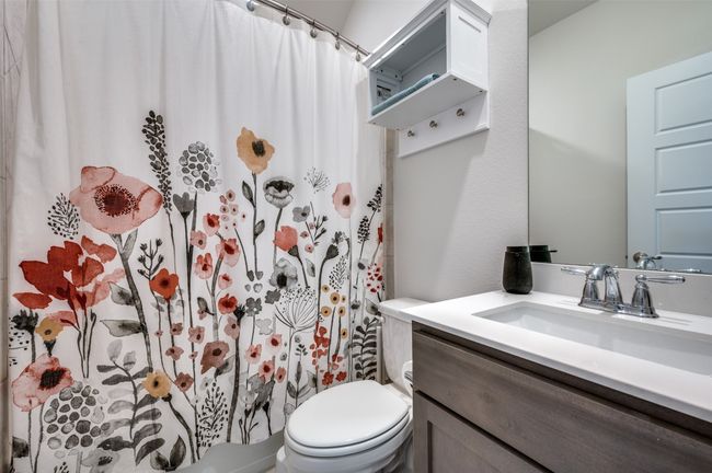 Full bathroom featuring vanity, a shower with curtain, and toilet | Image 22