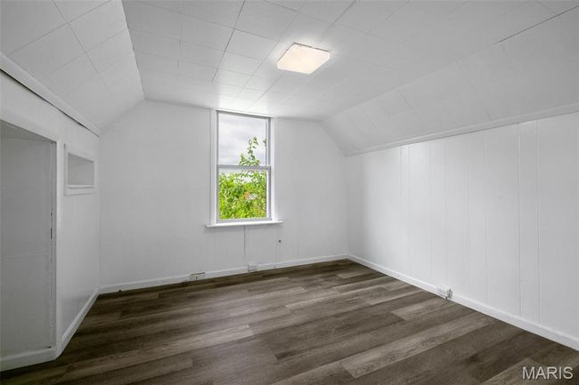 Additional living space featuring wood finished floors and lofted ceiling | Image 14