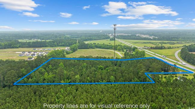 Aerial view of property and surrounding area featuring a forest and property parcel outlined | Image 15