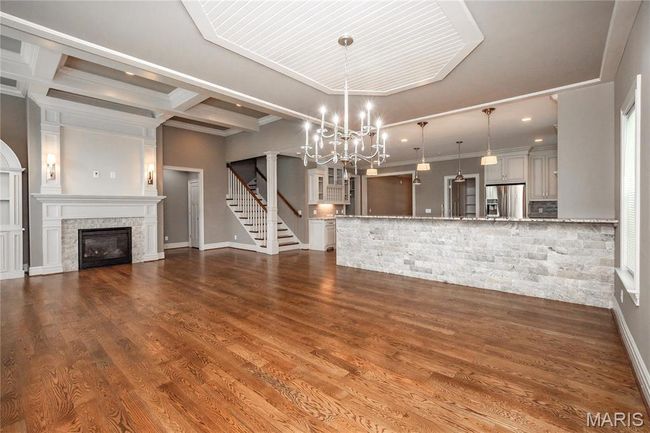 Separate dining room with an inviting chandelier, ornamental molding | Image 21