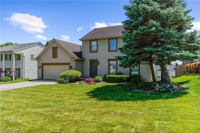 View of front of property featuring a garage and a front yard | Image 2