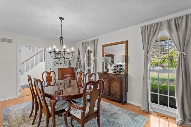 This is the living room that is currently being utilized as a dining room. | Image 14