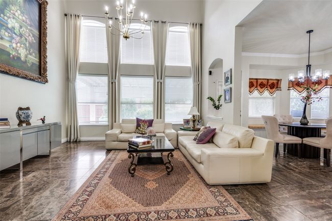 Grand family room with two story ceilings and a wall of windows. | Image 10