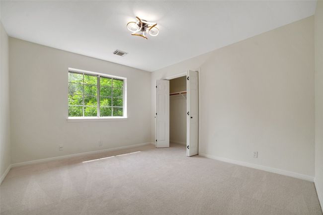 Unfurnished bedroom with light carpet, baseboards, and a closet | Image 18