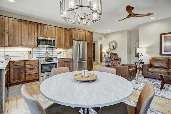 Dining room with recessed lighting, light wood finished floors, and ceiling fan with notable chandelier | Image 4