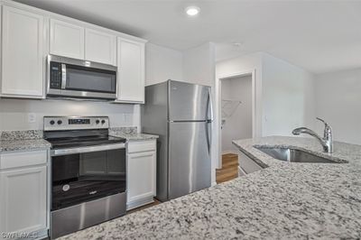 Solid wood 36" cabinets with crown molding. Granite counter tops, Whirlpool stainless steel appliances, and Moen Fauct. | Image 2