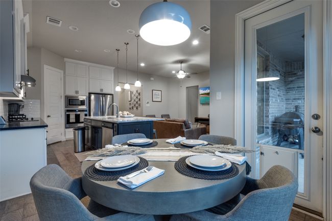 Dining room featuring visible vents, ceiling fan, and dark wood-style flooring | Image 9