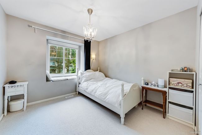 Bedroom featuring an inviting chandelier, light colored carpet, and baseboards | Image 17