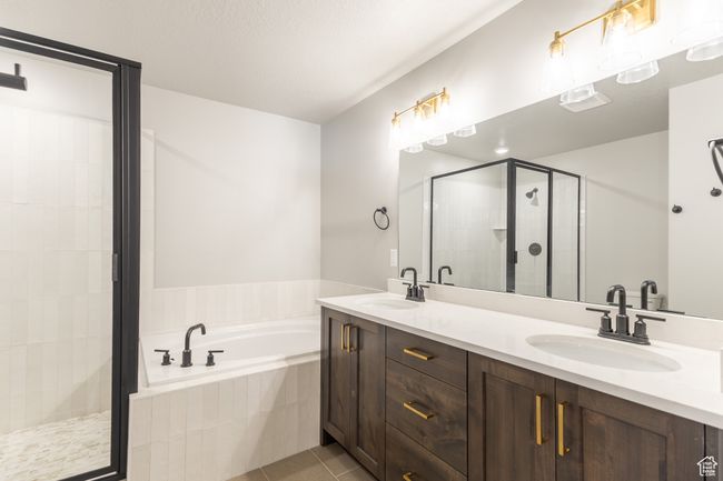 Full bath with a bath, double vanity, a shower stall, and tile patterned flooring | Image 17