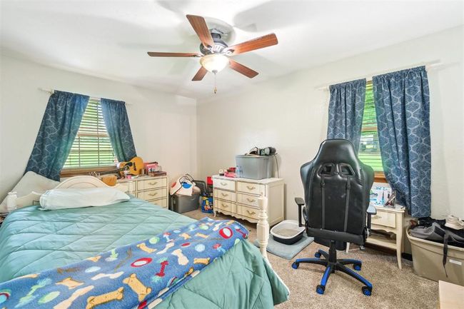 Carpeted bedroom with ceiling fan | Image 25