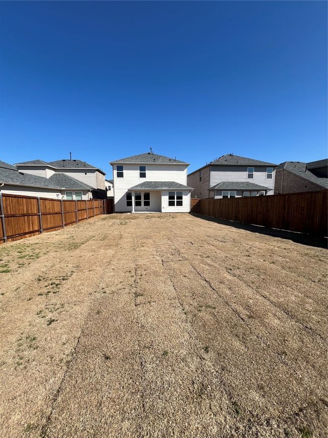 Back of property featuring a yard and a fenced backyard | Image 4