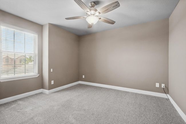 Spare room featuring carpet flooring, ceiling fan, and baseboards | Image 26
