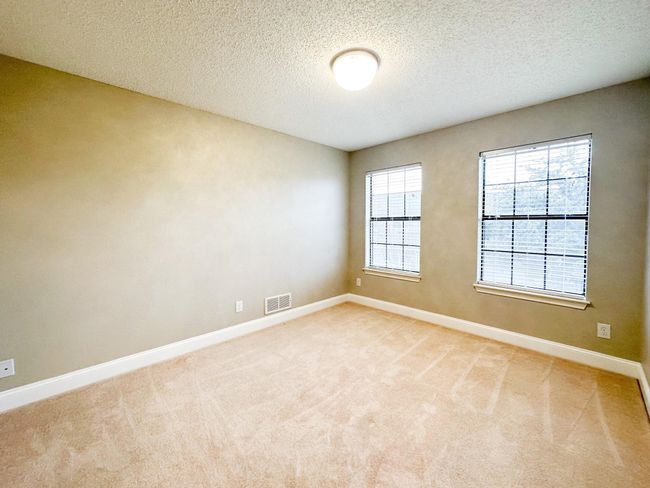 Unfurnished room featuring baseboards, a textured ceiling, and light carpet | Image 7