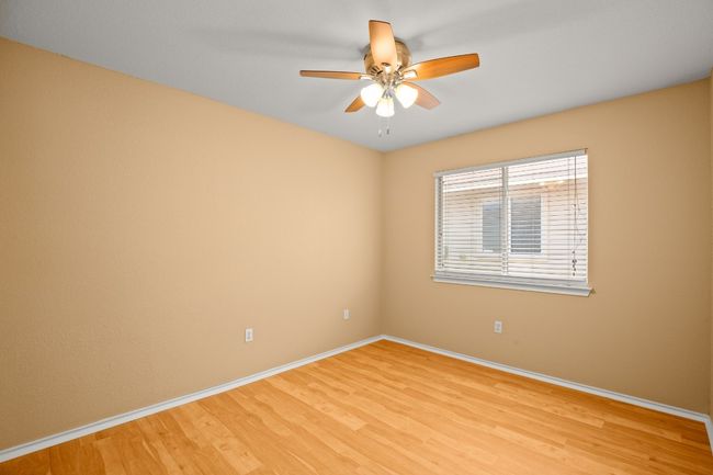 Spare room featuring baseboards, light wood-type flooring, and ceiling fan | Image 14