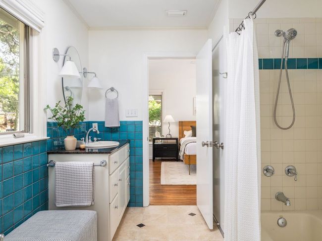 Bathroom with vanity, tile patterned floors, and a shower / bath combo. | Image 18