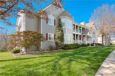 View of front facade featuring a balcony and a front lawn | Image 1