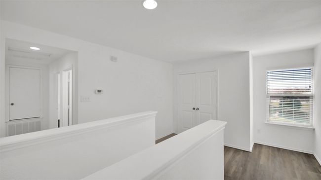 Corridor with visible vents, wood finished floors, an upstairs landing, and baseboards | Image 26