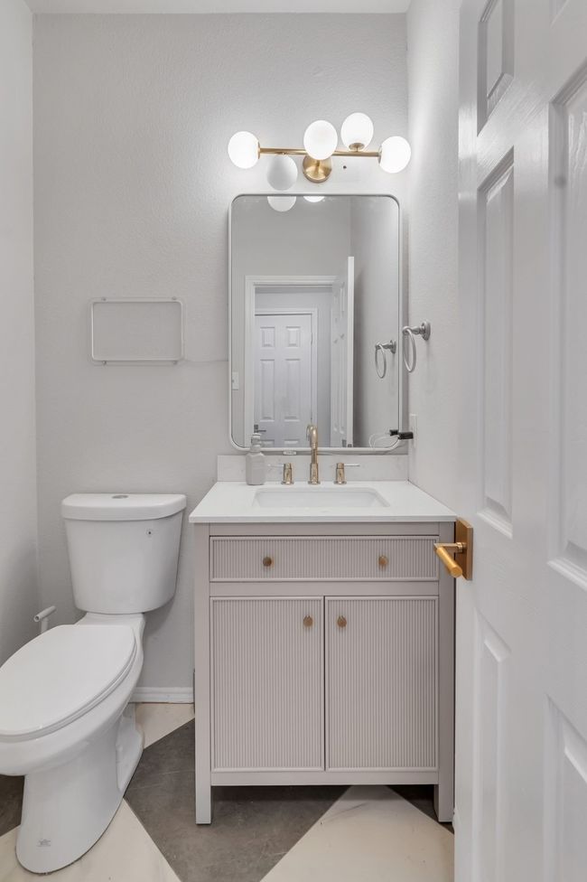 Bathroom featuring toilet, vanity, and baseboards | Image 17