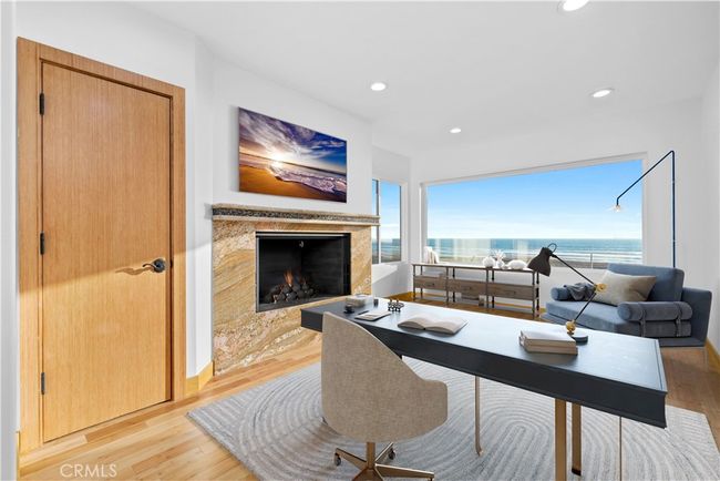 Secondary bedroom with closet and fireplace, staged as an office! | Image 27