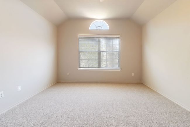 Carpeted spare room with baseboards and vaulted ceiling | Image 13