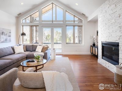 The sun-drenched great room showcases a soaring fifteen-foot vaulted ceiling, seemingly extending into the air to cultivate a feeling of expansive openness that is truly breathtaking. | Image 3