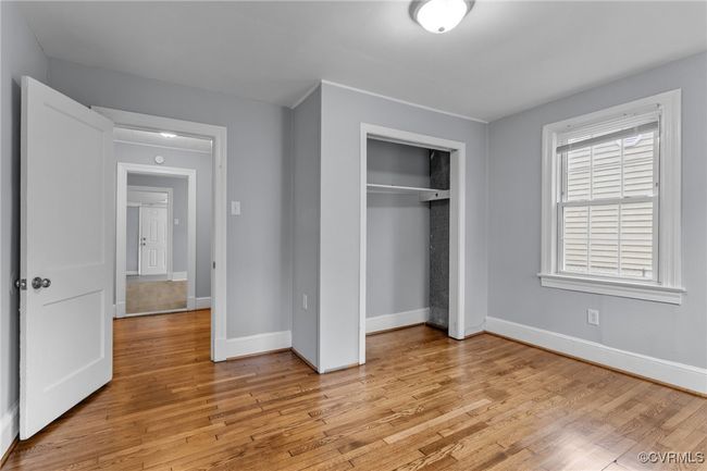 Unfurnished bedroom with baseboards, light wood-type flooring, and a closet | Image 9