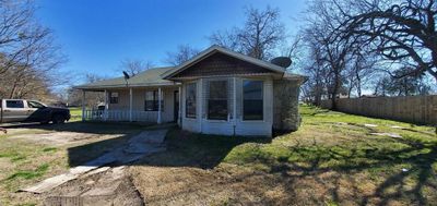 View of front facade featuring a porch and a front lawn | Image 1