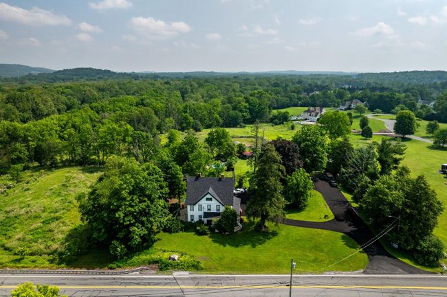 Aerial view of property and surrounding area with a forest | Image 44