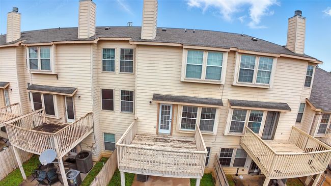 Rear view of property featuring a chimney and stairs | Image 33