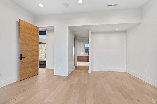Spare room featuring light wood finished floors, baseboards, visible vents, and recessed lighting | Image 22