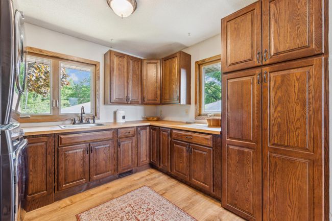 Additional view of the laundry/mudroom with generous cabinetry and countertop space—ideal for folding and organization. | Image 17
