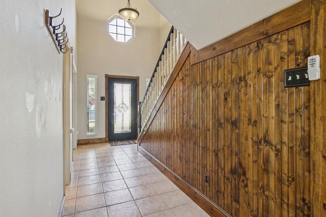 Entry way with tile floors. The beadboard adds a hint of rustic charm. | Image 4