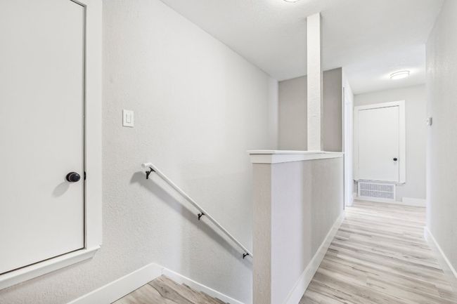 Staircase with baseboards and wood finished floors | Image 17