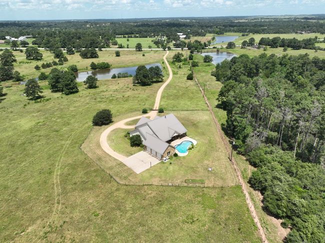 Rear Aerial Side/Rear View of Home with 3 Car Garage, Pool and Driveway. | Image 46
