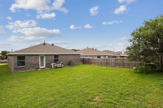 Back of house with brick siding, roof with shingles, and central air condition unit | Image 30