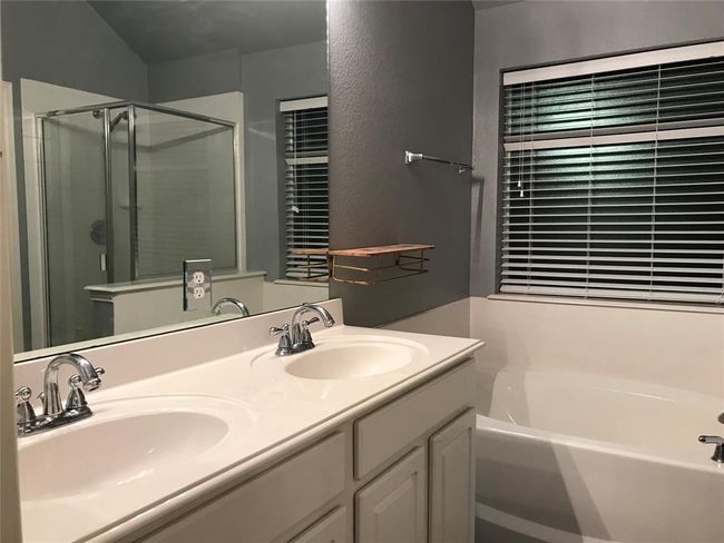 Full bath with double vanity, a shower stall, a bath, and a sink | Image 11
