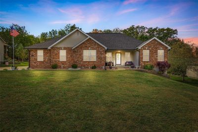 Single story home featuring a patio and a lawn | Image 1