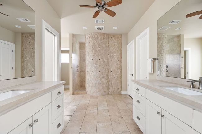 Dual vanities and ample storage make the primary bathroom both stylish and functional. | Image 16