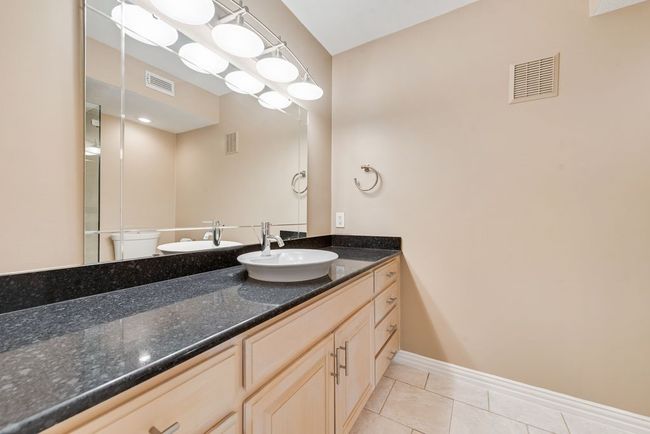 Bathroom with tile patterned floors, vanity, and visible vents | Image 7