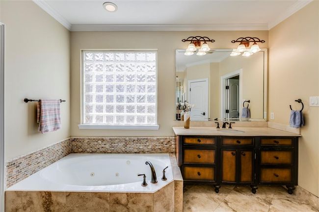 Wonderful custom Primary suite with beautiful tile, glass block window & jaccuzi bath | Image 26