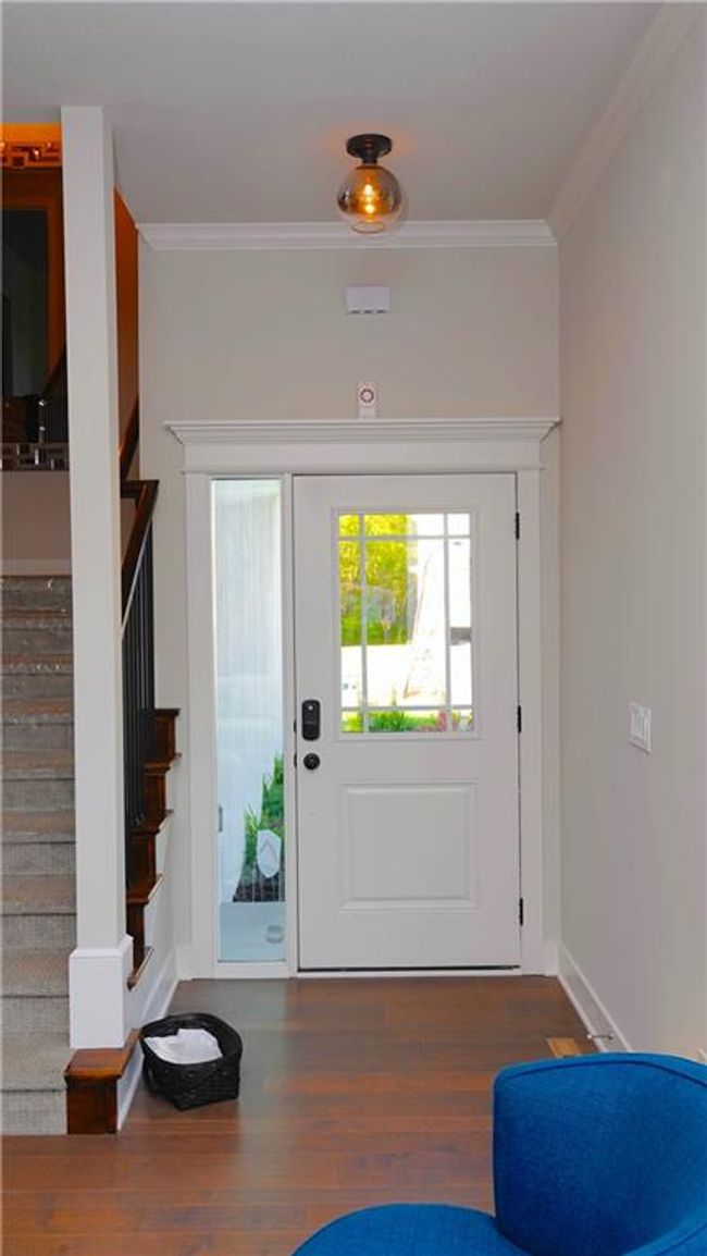 Entryway featuring stairs, ornamental molding, dark wood-type flooring, and baseboards | Image 7