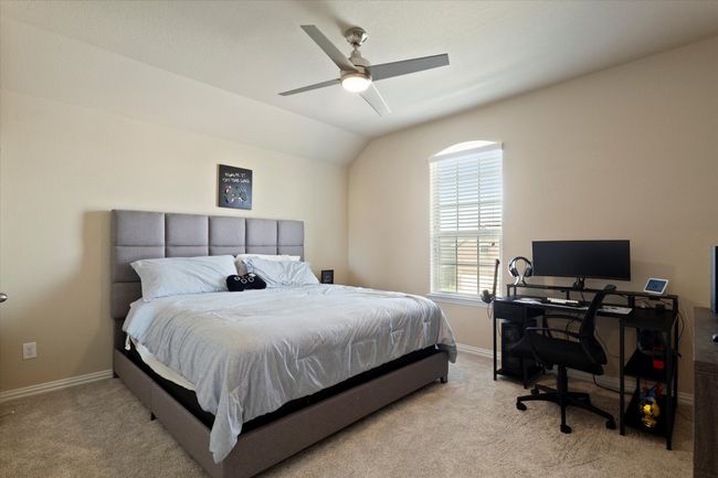Bedroom with carpet, an office area, baseboards, lofted ceiling, and a ceiling fan | Image 27